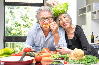 Middle aged couple happy cooking healthy