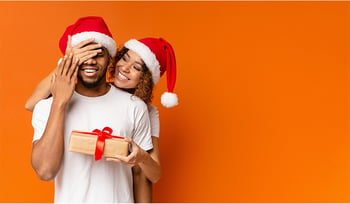 Girl giving boyfriend christmas gift