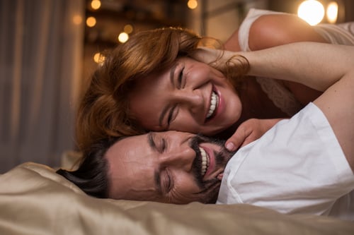 Portrait of happy mature man and woman are having fun in bedroom